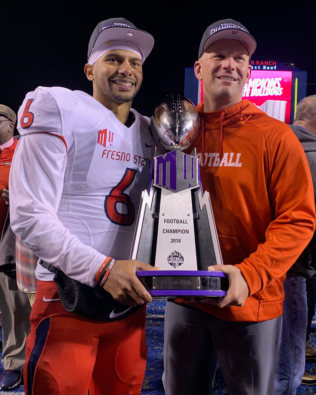 Marcus McMaryion holding the 2018 Mountain West Championship trophy